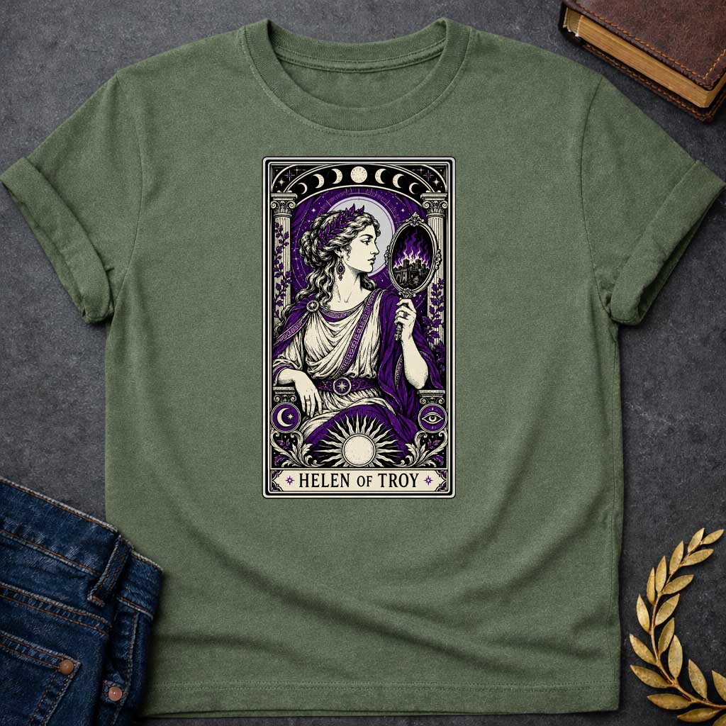 Military Green T-shirt with an intricate tarot card style graphic featuring Helen of Troy in a Dark Academia aesthetic. She wears a laurel wreath, Greek tunic, and purple robe, holding a hand mirror that reflects a burning city in purple flames. The design has a black, cream, and deep purple color scheme with mystical elements like moon phases, a radiant sun, and an eye symbol. A banner at the bottom reads "HELEN OF TROY" between two stars