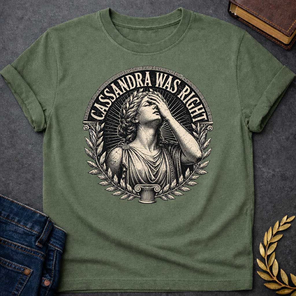 Military Green T-shirt with a classical engraving-style illustration of Cassandra, the Trojan prophetess, looking upward with one hand raised to her forehead in anguish. She wears flowing Greek robes with decorative brooch and Greek key pattern trim. Surrounded by laurel wreaths and flanked by Ionic columns. Radiating lines create a dramatic halo effect. Text 'CASSANDRA WAS RIGHT' curves along the top within a Greek key border. References the tragic myth of Cassandra, cursed to see the future but never be b
