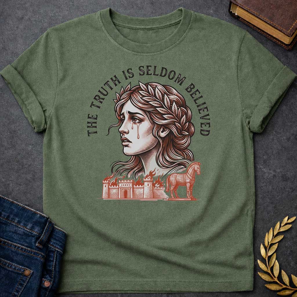 Military Green T-shirt with a A Greek mythology design featuring a detailed woodblock-engraving style illustration of a crying Cassandra in profile. She wears a laurel wreath, with tears streaming down her face. Arched above her is the text "THE TRUTH IS SELDOM BELIEVED" in a bold black serif font. Below her portrait, a burning ancient city wall and the Trojan Horse are illustrated in a fine-line, terracotta-orange style.