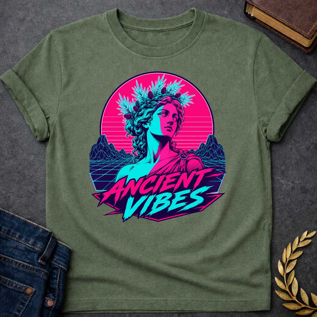 Military Green T-shirt with a Vaporwave-style illustration of a classical Greek Nymph bust in neon magenta and cyan. The figure wears a laurel wreath crown and draped robes with split-color digital aesthetic. Geometric mountains and grid pattern landscape create a retro 80s vibe. Horizontal scan lines suggest digital distortion. Bold text reads 'ANCIENT VIBES' in magenta and cyan with star accents. Navy blue border frames the design. Blends classical Greek aesthetics with modern synthwave style.