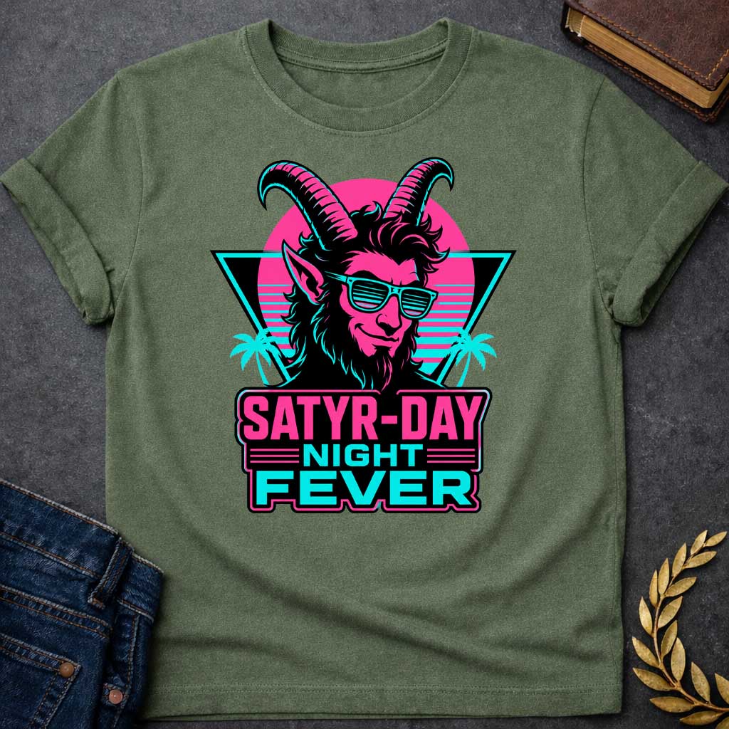 Military Green T-shirt with a vibrant 1980s synthwave-style graphic for "satry-day night fever.jpg". It features a cool satyr with large horns, a smirk, and cyan shutter shades, illuminated in neon pink and black. The background shows a retrowave sunset grid, a black triangle, and palm trees. Below, the punny title "SATYR-DAY NIGHT FEVER" is displayed in bold neon pink and cyan block lettering against a dark badge