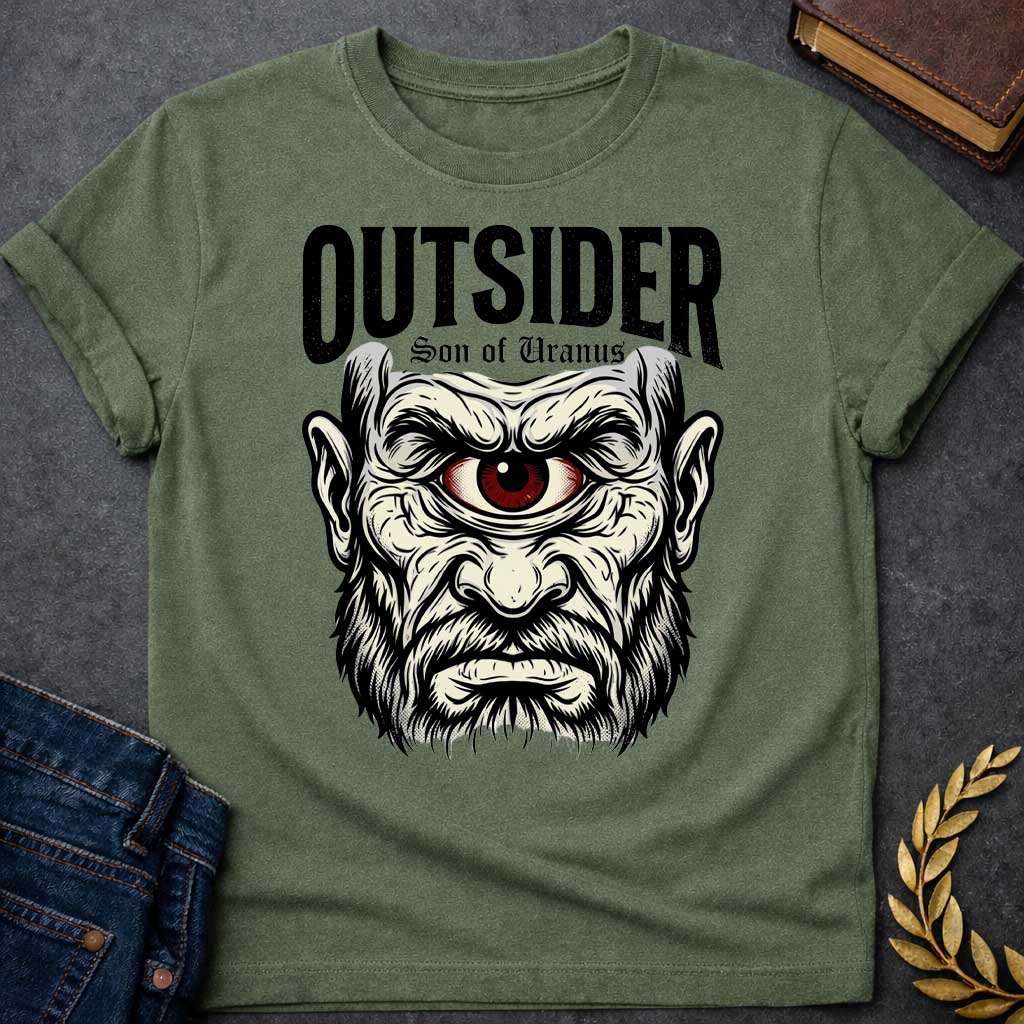 Military Green T-shirt with a Bold typography design featuring a single-eyed Titan face with fierce expression. Thick white beard and long flowing hair frame a menacing red eye with intense gaze. Black and white engraving style with intricate line work emphasizing the character's otherworldly nature. Text reads 'OUTSIDER' and 'Son of Uranus' referencing the Titans of Greek mythology. Celebrates mythological outsider status, divine rebellion, and powerful, untamed forces beyond mortal comprehension.
