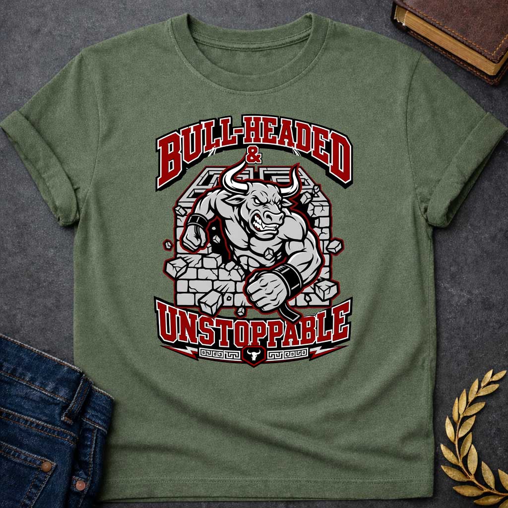 Military Green T-shirt with a High-impact sports design featuring a muscular Minotaur bursting through a crumbling stone wall in red, gray, and white. The aggressive bull-headed figure displays defined musculature and determination. Text reads 'Bull-Headed & Unstoppable' in bold red and black lettering. Greek key pattern and bull symbol anchor the bottom. Combines Greek mythology with modern gym and sports culture, celebrating stubborn strength and unstoppable power.