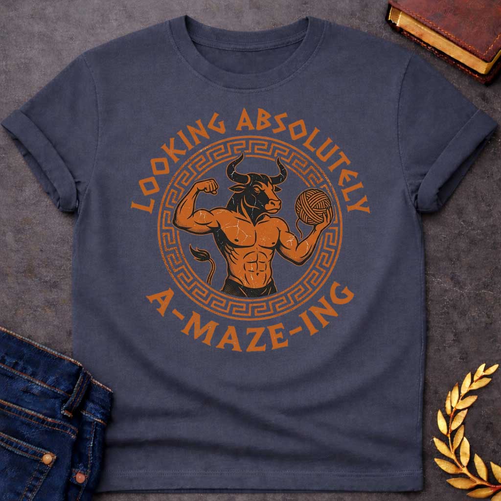 Dark Heather T-shirt with a Fitness-themed design of a muscular Minotaur displaying impressive abdominal definition and flexing one arm. The bull-headed figure holds a ball of yarn in the other hand, referencing the mythological thread used to escape the labyrinth. Terracotta orange and brown coloring with defined musculature. Greek key pattern border frames the circular composition. Text reads 'Looking Absolutely A-Maze-Ing' in bold black lettering. Clever wordplay blends gym culture with Greek mythology.