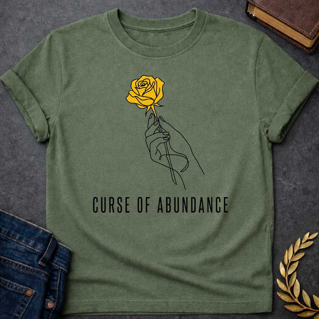 Military Green t-shirt with A Minimalist Greek mythology design featuring a continuous line-art hand delicately holding a golden rose, symbolizing King Midas' legendary golden touch. Below the illustration, the phrase "Curse of Abundance" appears in clean, modern typography. A simple black-and-gold aesthetic creates an elegant, understated design inspired by the tragic Midas myth.