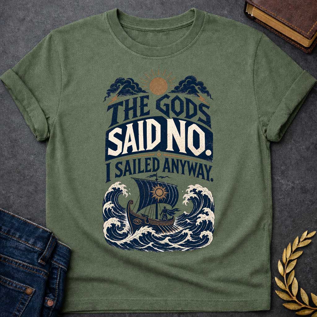 Military Green t-shirt with a Vintage Greek mythology design featuring the bold phrase “The Gods Said No. I Sailed Anyway.” An ancient Greek ship battles towering ocean waves beneath storm clouds, lightning bolts, and a glowing sun. Distressed navy, cream, and gold artwork captures the defiant spirit of Odysseus and The Odyssey.
