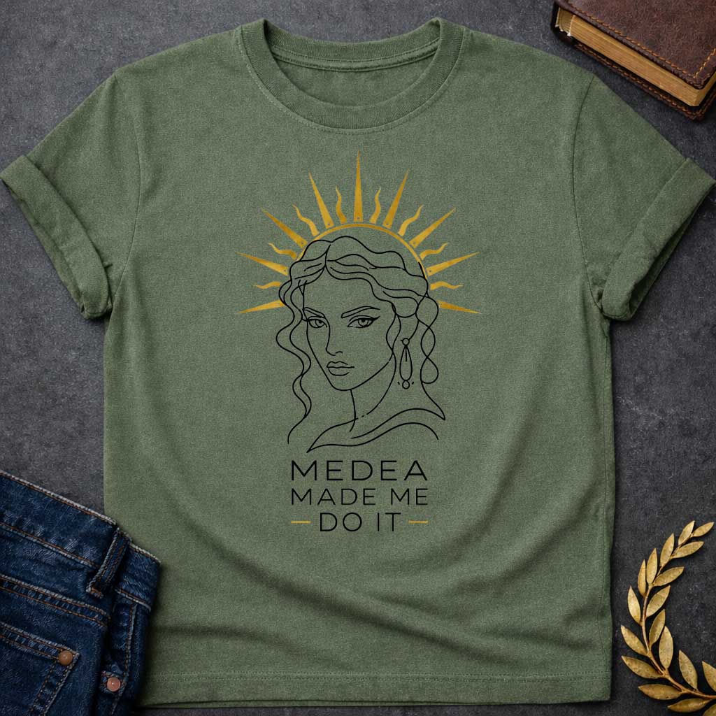 Military Green T-shirt with a Minimalist line art portrait of Medea with wavy hair and drop earrings, framed by a golden radiating sun halo. Black and white design with gold accents. Text reads 'Medea Made Me Do It.' Humorous reference to blaming the legendary Greek sorceress for chaotic or destructive actions. Celebrates Medea's infamous power and magical influence with tongue-in-cheek blame attribution.