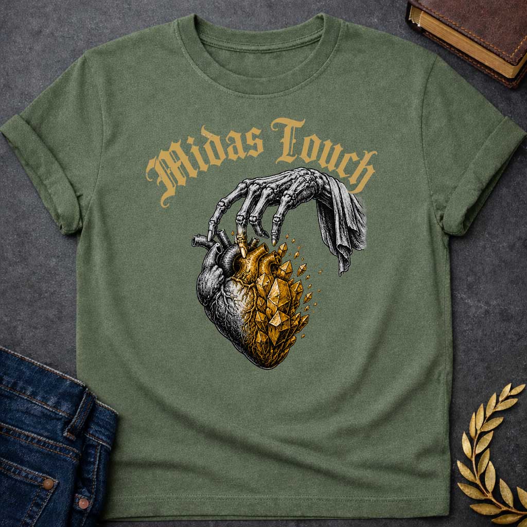 Military Green t-shirt with A Vintage engraving-style Greek mythology design featuring a skeletal hand with the Midas touch transforming half of an anatomical heart into shimmering gold crystals. Above the illustration, gothic lettering reads "Midas Touch." Inspired by the tragic King Midas myth, the design symbolizes how greed and the pursuit of wealth can harden the heart, using bold black and metallic gold artwork.