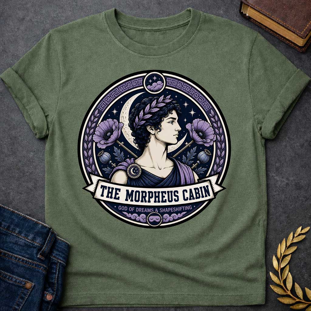 Military Green t-shirt with a Morpheus Greek mythology cabin design featuring the god of dreams and shapeshifting in a navy and lavender circular emblem. Morpheus wears a laurel crown and classical robes, surrounded by a crescent moon, stars, purple poppies, poppy pods, clouds, and Greek key details. Text reads “The Morpheus Cabin” and “God of Dreams & Shapeshifting,”
