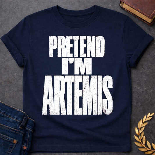 Navy t-shirt with a Pretend I’m Artemis Greek mythology design featuring bold distressed white typography on a transparent background. The stacked text reads “PRETEND I’M ARTEMIS” in a rugged vintage block font, creating a humorous design inspired by Artemis, the Greek goddess of the hunt, wilderness, wild animals, archery, and the moon.