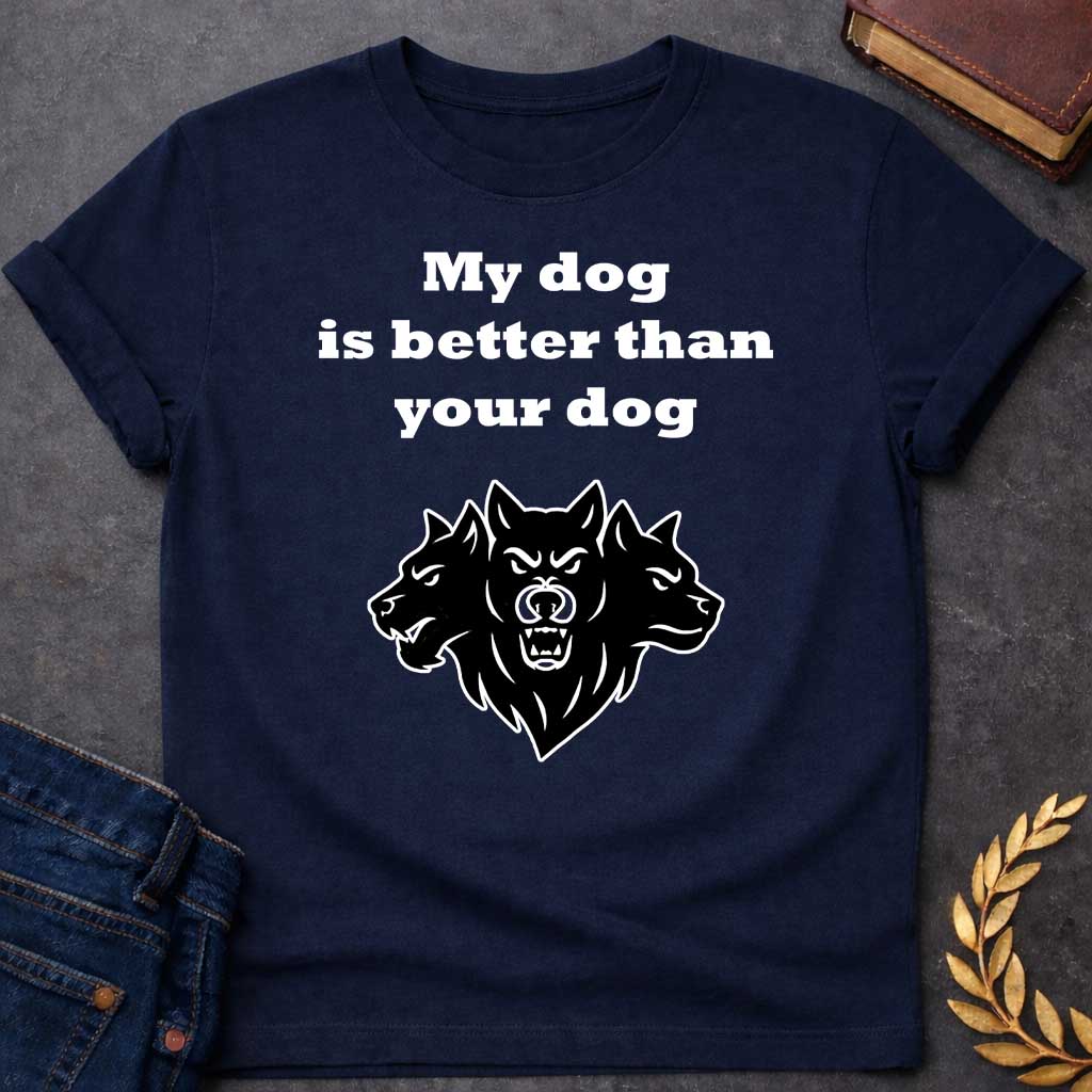 Navy T-shirt graphic in black and white featuring bold serif text reading "My dog is better than your dog" above a flat black silhouette illustration of Cerberus, the three-headed dog of the underworld, with the center head facing forward snarling and the two side heads in profile, in a humorous nod to Hades from Greek mythology, designed for a light-coloured shirt