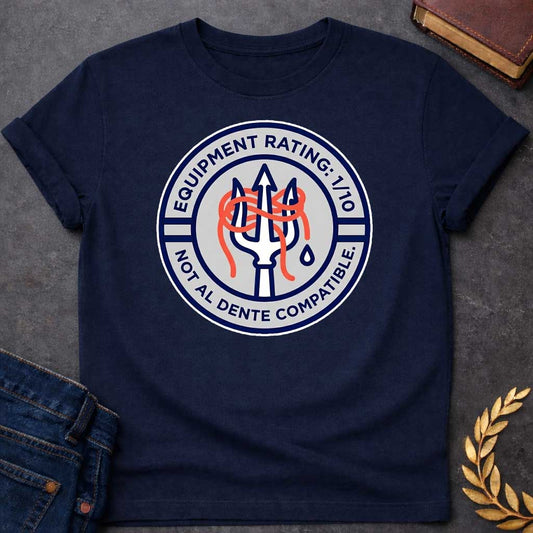 Navy T-Shirt A circular patch-style graphic design. The design features a light gray inner circle surrounded by a thick navy blue border.  In the center, a white trident outlined in navy blue has a tangle of bright orange spaghetti coiled around its tines. A single blue water droplet sits to the right of the trident's handle.  The top half of the navy border contains the white text: "EQUIPMENT RATING: 1/10".  The bottom half of the border contains the white text: "NOT AL DENTE COMPATIBLE."  The entire emble
