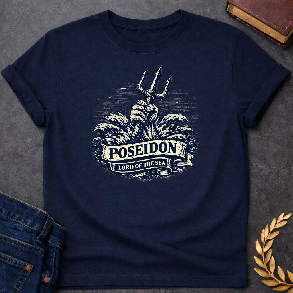 Navy T-shirt graphic in a vintage nautical woodcut style featuring a powerful fist rising from crashing ocean waves while gripping a trident upright, with a scroll banner across the middle reading "Poseidon" above and "Lord of the Sea" below, referencing Poseidon, the Greek God of the Sea