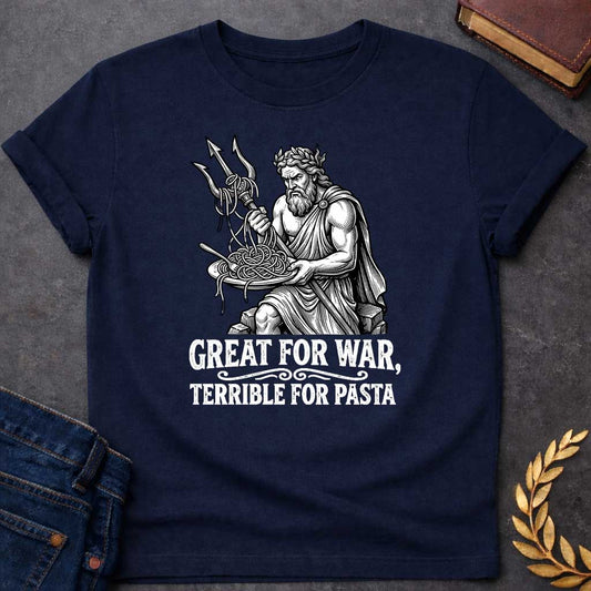 Navy T-shirt graphic in black and white featuring a detailed engraving-style illustration of Poseidon seated on rocks wearing a laurel wreath and draped robe, holding a trident in one hand with spaghetti tangled around its prongs, while balancing a plate of pasta in his other hand and looking frustrated. Bold distressed white text below with decorative scroll divider reads "Great for War, Terrible for Pasta" — a humorous nod to Poseidon, the Greek God of the Sea