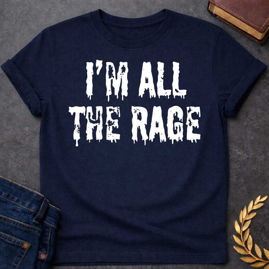 Navy T-shirt graphic in white featuring large dripping horror-style text reading "I'm All the Rage" — a double entendre playing on both popular trends and the furious wrath of Ares, the Greek God of War, rendered in a distressed melting font