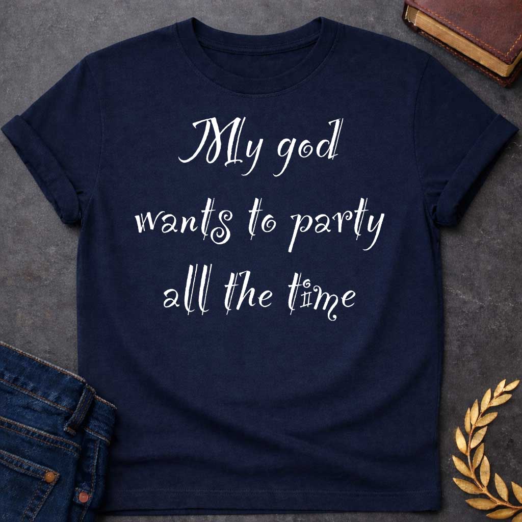 Navy T-shirt graphic white text featuring whimsical hand-lettered calligraphy-style text reading "My god wants to party all the time" — a humorous nod to Dionysus, the Greek God of Wine and Revelry