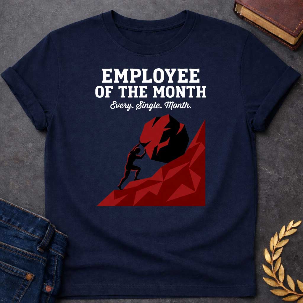 Navy T-shirt with a graphic featuring bold dark grey slab serif text reading "Employee of the Month" with a script subtitle reading "Every. Single. Month." above a low-polygon geometric illustration of Sisyphus as a black silhouette straining to push an enormous dark red boulder up a steep angular red hill — a humorous reference to the Greek myth of Sisyphus, condemned to roll a boulder uphill for eternity