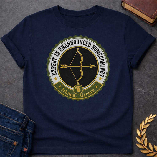 Navy T-shirt with a graphic featuring a vintage military challenge coin-style badge design in olive green, black, gold, and white. A golden bow and arrow are centered on a black background within the circular badge, with text arched around the outer ring reading "Expert in Unannounced Homecomings" flanked by gold stars. A green ribbon banner at the bottom features a Spartan helmet medallion and reads "Ithaca, Greece" with gold stars — a humorous reference to Odysseus, the hero of Homer's Odyssey who famousl