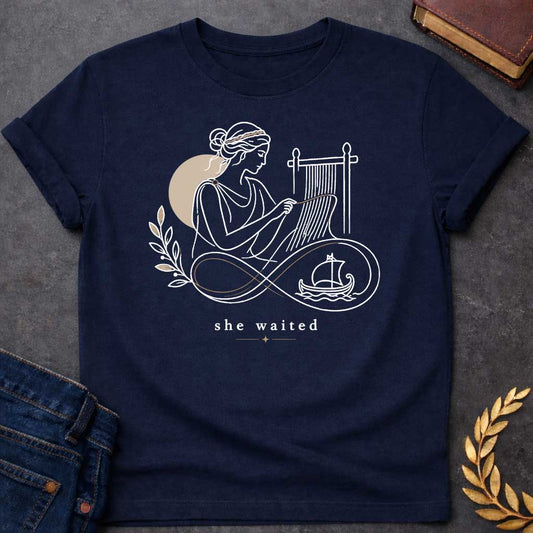 Navy T-Shirt with a Minimalist line art of Penelope weaving at a loom, wearing classical Greek robes with braided hair. Rendered in elegant black linework with tan accents. An infinity symbol flows from the loom, incorporating an olive branch and Greek ship, symbolizing endless waiting for Odysseus. Text reads 'she waited' in serif font with decorative star. Gentle design honoring Penelope's faithful devotion and patience during her husband's 20-year absence.