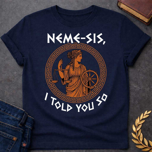 Navy T-shirt with an Ancient Greek pottery-style illustration of Nemesis, the goddess of divine retribution, rendered in terracotta and black. She wears flowing robes and holds balanced scales of justice in one hand and a ship's wheel in the other, symbolizing fate and accountability. Her braided hair is styled in classical Greek fashion. Enclosed in a Greek key pattern circular border. Bold text reads 'NEMESIS, I TOLD YOU SO' above and below. References the goddess who ensures justice.
