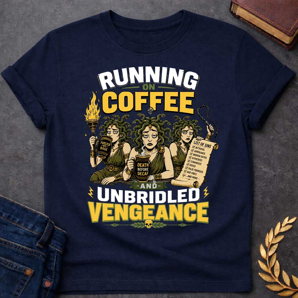 Navy T-shirt with a Humorous illustration blending Greek mythology with coffee culture. Three Furies with serpent hair wear classical robes holding symbols of vengeance. Left holds a flaming torch labeled 'Fueled by Rage,' center holds a coffee cup reading 'Death Before Decaf,' right carries a scroll listing sins. Text reads 'Running on Coffee and Unbridled Vengeance' above and below. Gold and black scheme celebrates divine justice powered by caffeine addiction.