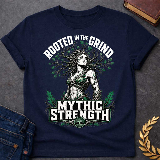 Navy T-shirt with a gym-style Greek mythology t-shirt design featuring a highly muscular tree nymph. Her hair transitions into a massive, sprawling network of oak branches filled with green leaves. Arched above her is the text "ROOTED IN THE GRIND" in a distressed block font. Below her powerful physique, a bold green and white emblem reads "MYTHIC STRENGTH," anchored at the bottom by a circular tree of life icon