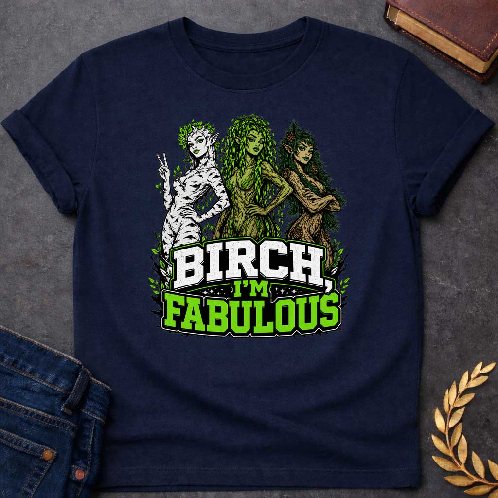 Navy T-shirt with a pun-based Greek mythology t-shirt design featuring a detailed engraving-style portrait of a hamadryad emerging from a birch trunk. She has long flowing hair, wears a floral wreath, and looks aside with a dramatic, sassy expression. Arched above her head is the bold black text "BIRCH, I'M FABULOUS" in a clean serif font. The entire graphic uses an elegant, fine-line black and white aesthetic