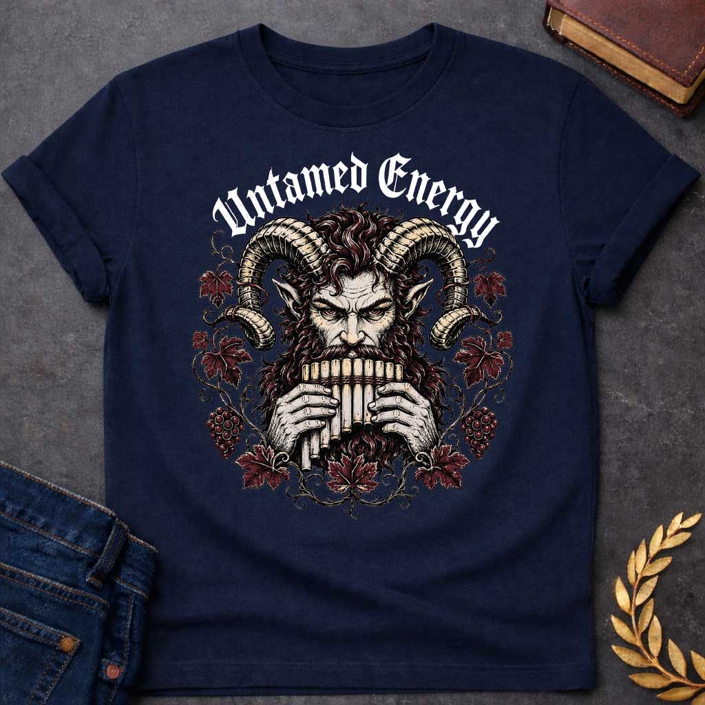 Navy T-shirt with a heavy metal style t-shirt graphic. It features a powerful, intense satyr or Pan figure with large, curling ram horns playing a pan flute. His fierce face is framed by a circular wreath of detailed, twisting grapevines, deep purple-red autumn leaves, and clusters of grapes. Arched directly above the illustration, the phrase "Untamed Energy" is written in a bold, white gothic font