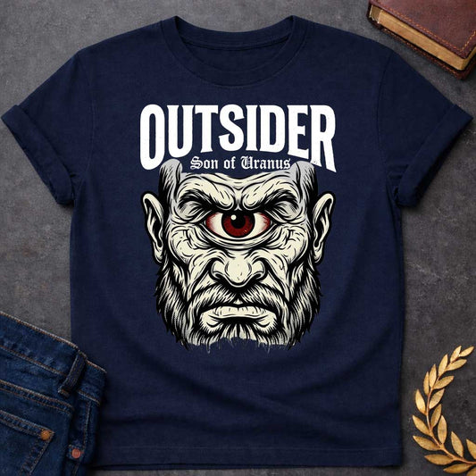 Navy T-shirt with a Bold typography design featuring a single-eyed Titan face with fierce expression. Thick white beard and long flowing hair frame a menacing red eye with intense gaze. Black and white engraving style with intricate line work emphasizing the character's otherworldly nature. Text reads 'OUTSIDER' and 'Son of Uranus' referencing the Titans of Greek mythology. Celebrates mythological outsider status, divine rebellion, and powerful, untamed forces beyond mortal comprehension.