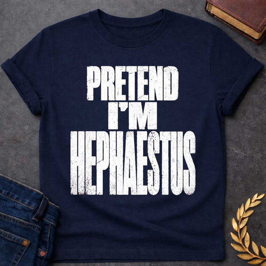 Navy t-shirt with a Pretend I’m Hephaestus Greek mythology design featuring bold distressed white typography on a transparent background. The stacked text reads “PRETEND I’M HEPHAESTUS” in a rugged vintage block font, creating a humorous design inspired by Hephaestus, the Greek god of fire, metalworking, blacksmiths, craftsmanship, and the forge.