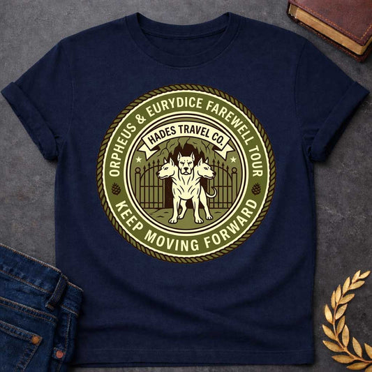 Navy t-shirt in vintage travel-badge style: three-headed Cerberus stands guard before an underworld cave gate. Olive green and cream circular design with rope border reads "Orpheus & Eurydice Farewell Tour" above and "Keep Moving Forward" below, with pinecone icons and stars flanking the scene.