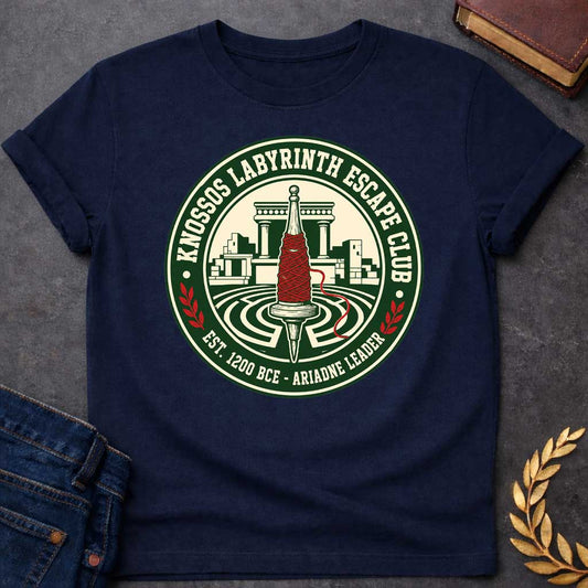 Navy T-shirt with A circular, collegiate-style emblem t-shirt design, The logo features a cream center showing a wooden spindle wrapped in bright red thread, positioned over a labyrinth with ancient Minoan ruins behind it. The dark green outer ring reads "KNOSSOS LABYRINTH ESCAPE CLUB" along the top and "EST. 1200 BCE - ARIADNE LEADER" at the bottom, separated by small red laurel branches.