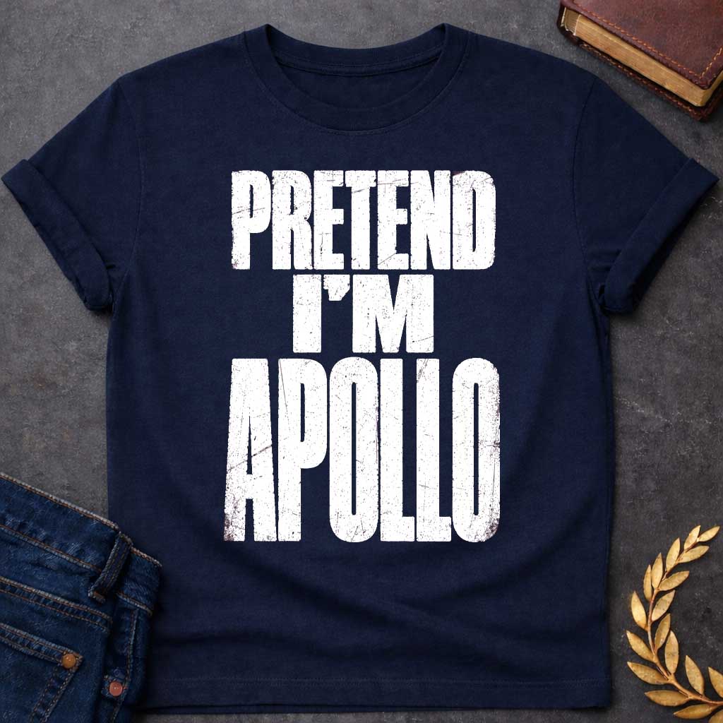 Navy t-shirt with a Pretend I’m Apollo Greek mythology design featuring bold distressed white typography on a transparent background. The stacked text reads “PRETEND I’M APOLLO” in a rugged vintage block font, creating a simple humorous design inspired by Apollo, the Greek god of the sun, music, poetry, prophecy, and healing.