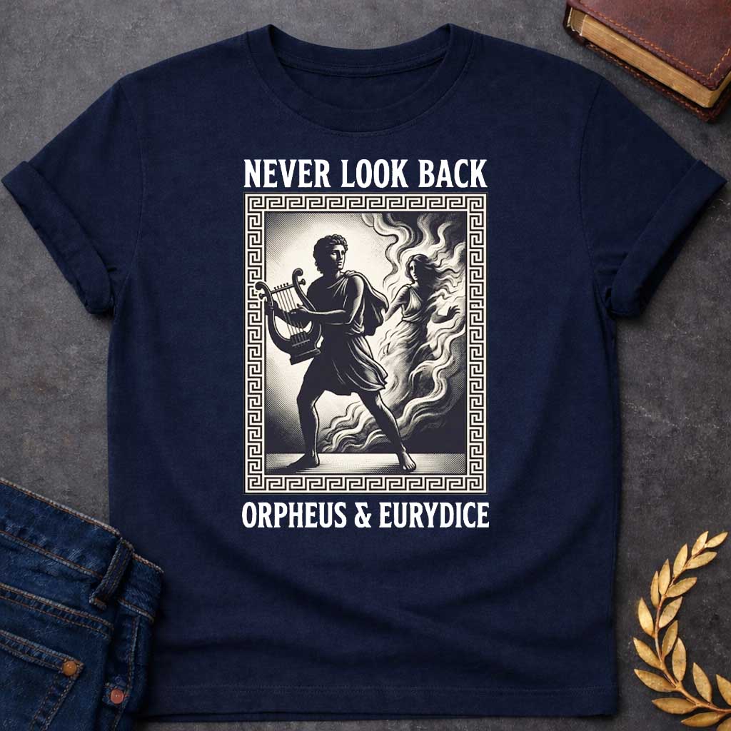 Navy t-shirt in engraved woodcut style: Orpheus strides forward carrying a lyre while Eurydice dissolves into smoke and shadow behind him, reaching out. The scene sits within a Greek key-patterned rectangular border, framed by bold serif text above and below, on a cream and black palette.