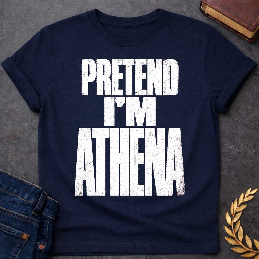 Navy t-shirt with a Pretend I’m Athena Greek mythology design featuring bold distressed white typography on a transparent background. The stacked text reads “PRETEND I’M ATHENA” in a rugged vintage block font, creating a humorous design inspired by Athena, the Greek goddess of wisdom, warfare, strategy, and crafts.