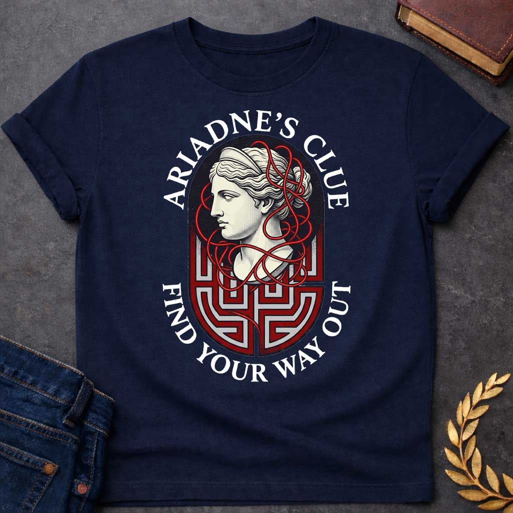 Navy T-shirt with A Classical portrait of Ariadne rendered in cream and red showing her in profile with wavy hair. Red thread winds decoratively around her head and neck, referencing her legendary ball of thread that guided Theseus through the labyrinth. A Greek key maze pattern in red and gray forms the base below her portrait. Text reads 'Ariadne's Clue' above and 'Find Your Way Out' below. Celebrates the mythological heroine's wisdom and the power of guidance through impossible challenges