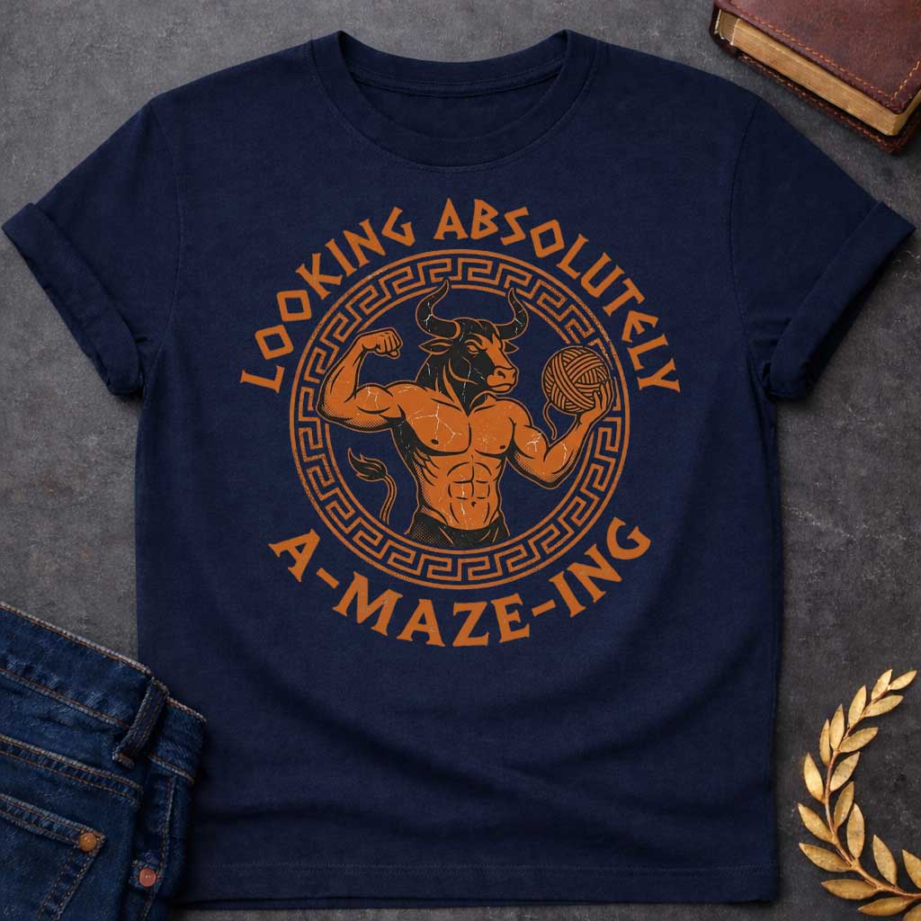Navy T-shirt with a Fitness-themed design of a muscular Minotaur displaying impressive abdominal definition and flexing one arm. The bull-headed figure holds a ball of yarn in the other hand, referencing the mythological thread used to escape the labyrinth. Terracotta orange and brown coloring with defined musculature. Greek key pattern border frames the circular composition. Text reads 'Looking Absolutely A-Maze-Ing' in bold black lettering. Clever wordplay blends gym culture with Greek mythology.