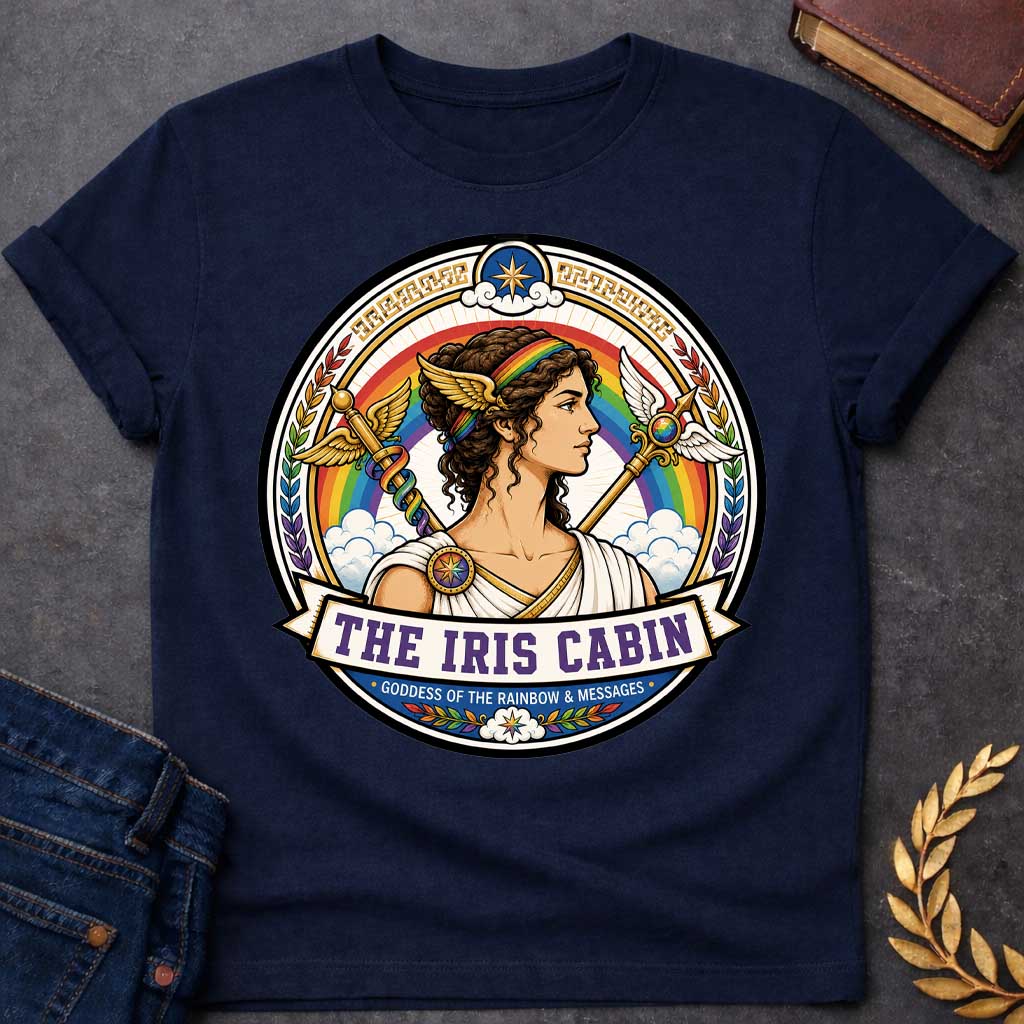 Navy T-shirt with a Iris Greek mythology cabin design featuring the goddess of the rainbow and messages in a colorful circular emblem. Iris wears a rainbow headband and winged accents, surrounded by a vibrant rainbow, clouds, winged staffs, laurel leaves, and celestial details. Text reads “The Iris Cabin” and “Goddess of the Rainbow & Messages,”