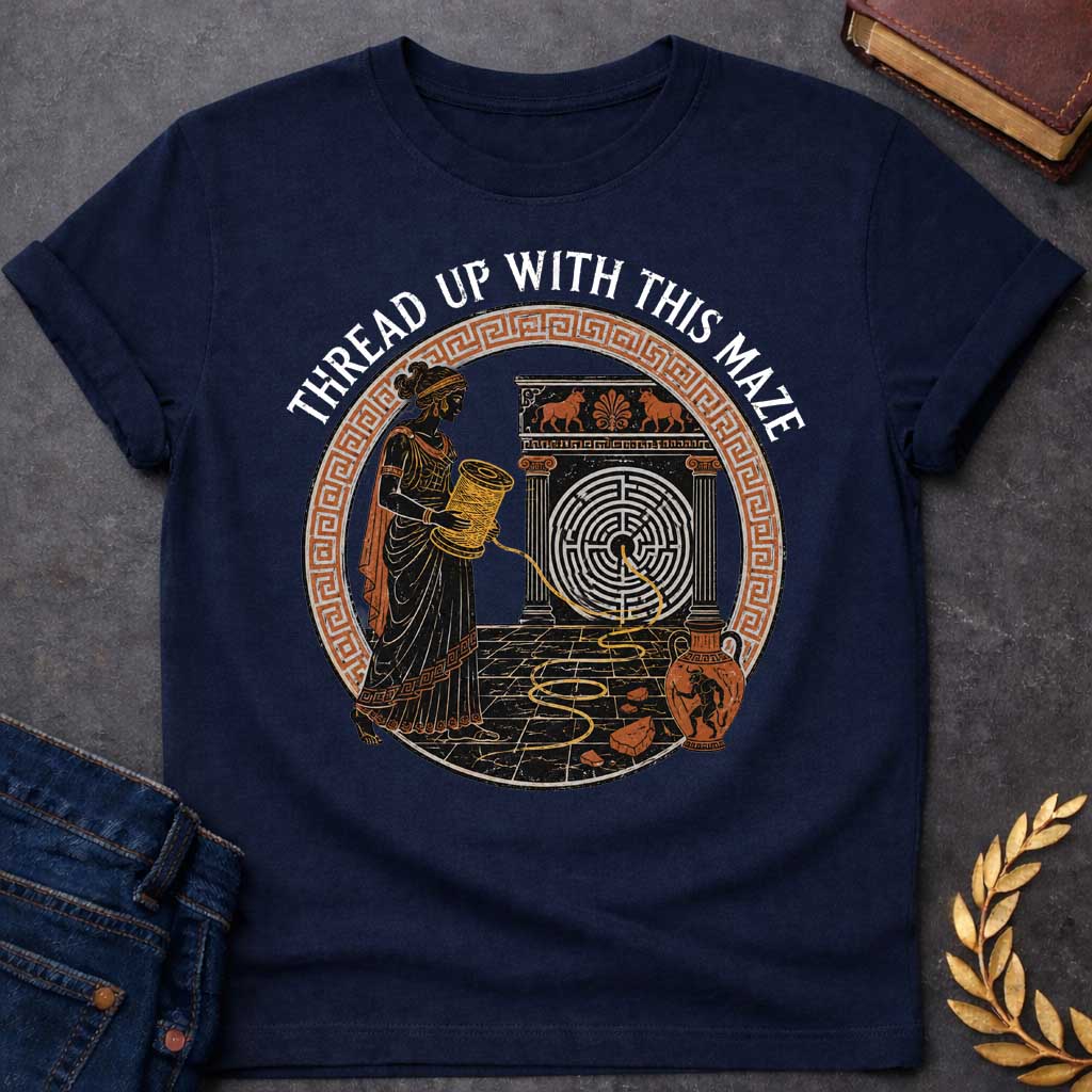 Navy T-shirt with A distressed, ancient Greek pottery-style t-shirt graphic. Inside a circular terracotta Greek key frame, a black figure of Ariadne holds a large spool, unwinding a golden thread that leads into a circular maze on a stone structure. An amphora vase with a Minotaur stands nearby. Arched above the scene, white text reads "THREAD UP WITH THIS MAZE" in a rustic serif font.