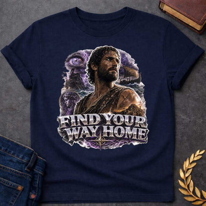 Navy t-shirt with an Epic Greek mythology design featuring Odysseus against a stormy seascape with lightning, a sailing ship, ancient ruins, and a mysterious watchful eye. A portrait of a woman appears within the dramatic collage, symbolizing his journey back to Ithaca. Bold metallic lettering reads "Find Your Way Home," capturing the adventure and perseverance of The Odyssey.