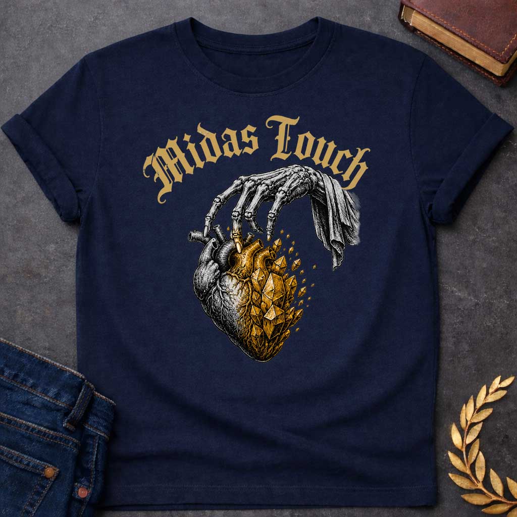 Navy t-shirt with A Vintage engraving-style Greek mythology design featuring a skeletal hand with the Midas touch transforming half of an anatomical heart into shimmering gold crystals. Above the illustration, gothic lettering reads "Midas Touch." Inspired by the tragic King Midas myth, the design symbolizes how greed and the pursuit of wealth can harden the heart, using bold black and metallic gold artwork.