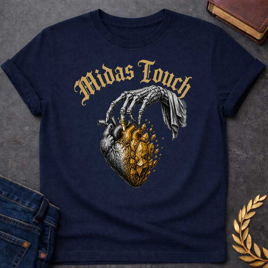 Navy t-shirt with A Vintage engraving-style Greek mythology design featuring a skeletal hand with the Midas touch transforming half of an anatomical heart into shimmering gold crystals. Above the illustration, gothic lettering reads "Midas Touch." Inspired by the tragic King Midas myth, the design symbolizes how greed and the pursuit of wealth can harden the heart, using bold black and metallic gold artwork.