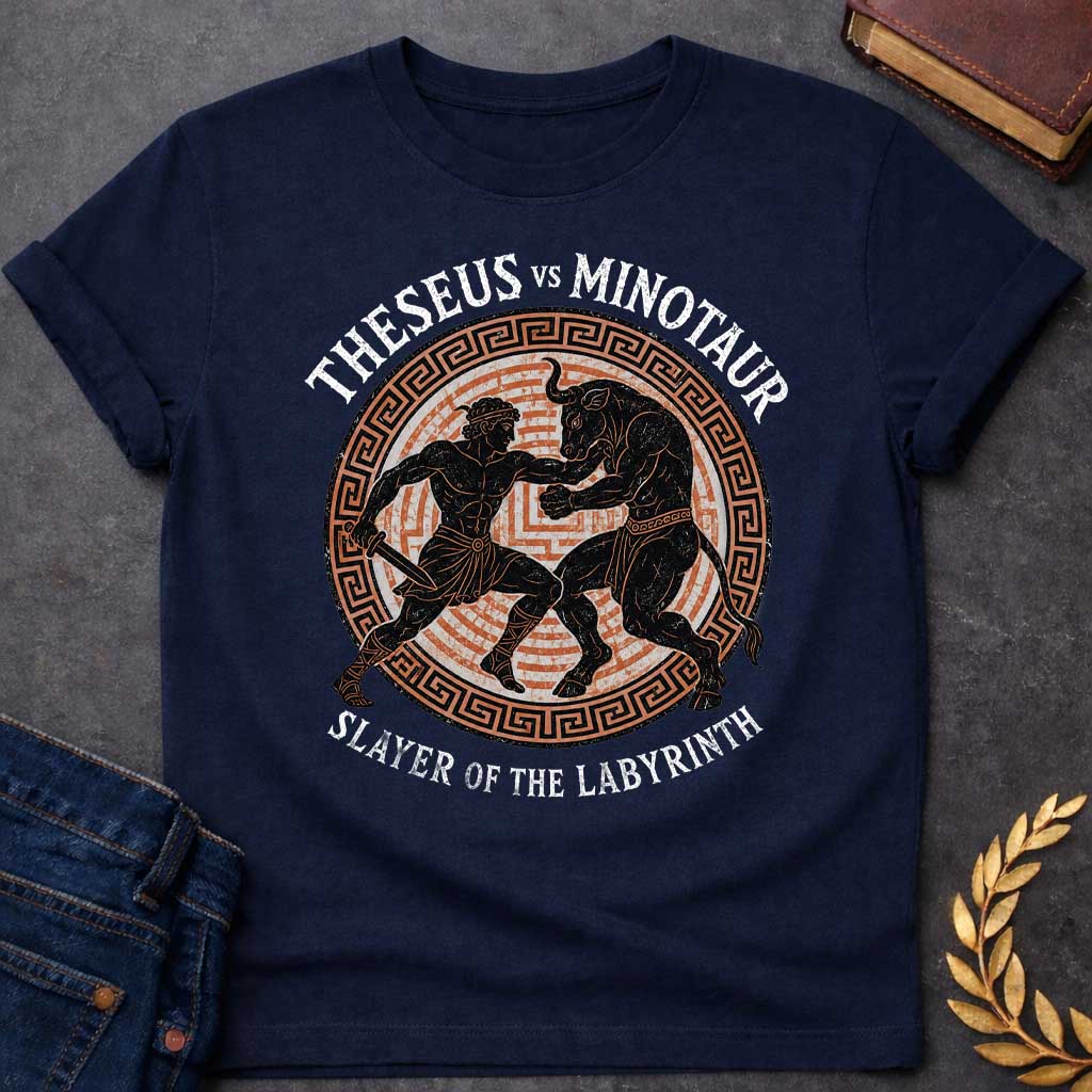 Navy T-shirt with A vintage, Greek pottery-style graphic depicting a battle. At the center, the muscular hero Theseus holds a sword as he wrestles the powerful Minotaur. The black figure silhouettes are set against an orange labyrinth pattern inside a circular frame with a Greek key border. Distressed text reads "THESEUS VS MINOTAUR" arched across the top and "SLAYER OF THE LABYRINTH" curved along the bottom.