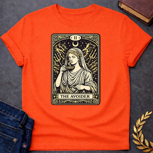 Orange T-shirt design in the style of a vintage tarot card. It features a woman in classical Greek robes calmly sipping from a cup. Behind her, lightning strikes and two tridents emerge from turbulent clouds under a crescent moon. The card is labeled with Roman numeral "II" at the top and the text "THE AVOIDER" in a banner at the bottom, all rendered in a cream and black woodcut aesthetic.