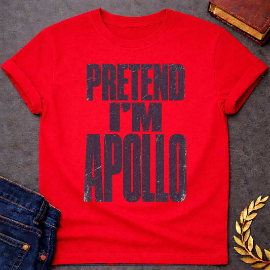 Red t-shirt with a Pretend I’m Apollo Greek mythology design featuring bold distressed purple typography on a transparent background. The stacked text reads “PRETEND I’M APOLLO” in a rugged vintage block font, creating a simple humorous design inspired by Apollo, the Greek god of the sun, music, poetry, prophecy, and healing.
