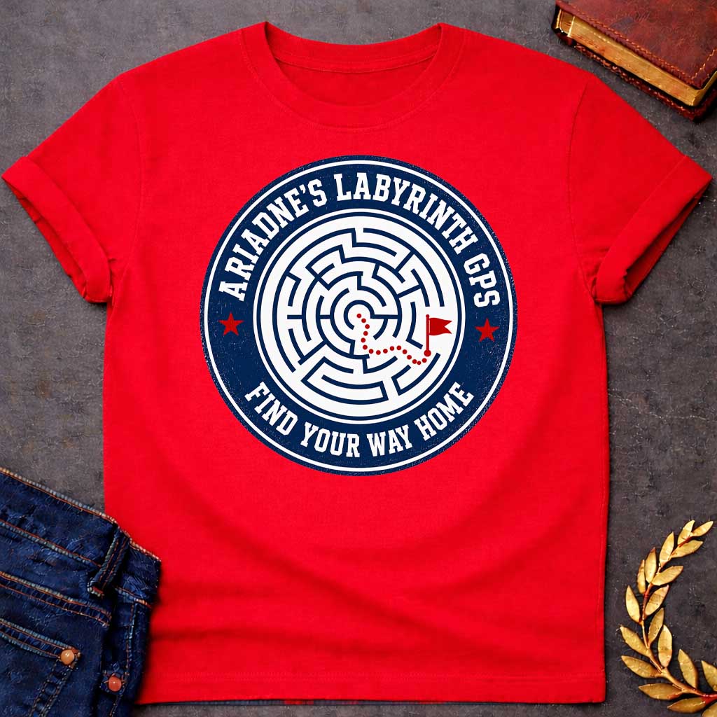 Red T-shirt with A Circular emblem with concentric maze in navy and white, featuring a red dotted path through the labyrinth toward a flag marker. Red stars accent the design. Text reads 'Ariadne's Labyrinth GPS' around the border and 'Find Your Way Home' below. Merges Greek mythology with modern GPS technology, presenting the legendary thread as contemporary guidance. Celebrates finding home through challenging mazes.
