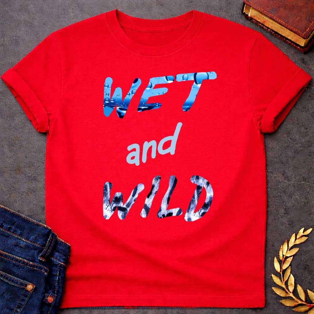 Red T-Shirt with a graphic design featuring the phrase "WET and WILD" in three stacked rows. The word "WET" is at the top in a large, bold, sans-serif font. The letters are filled with a high-definition image of bright blue water and splashing droplets. The word "and" is in the center in a smaller, lowercase, light-blue cursive-style font. The word "WILD" is at the bottom in the same large, bold font as "WET," but the letters are filled with a black-and-white leopard or cheetah print pattern