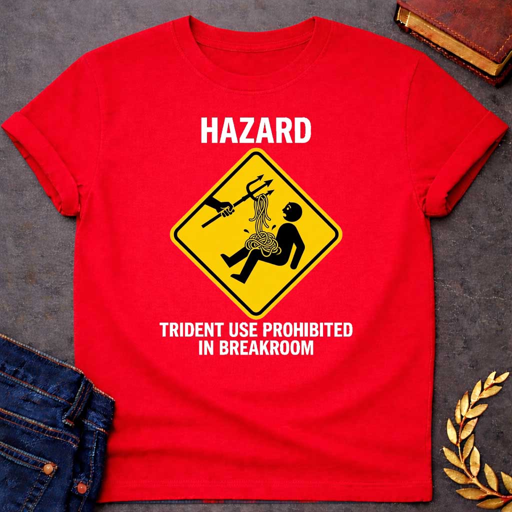 Red T-Shirt with a humorous design featuring a bold, yellow, diamond-shaped warning sign. Inside the sign, a stick figure falls backward, looking shocked as a pile of tangled yellow spaghetti spills from their chest and stomach. Above them, an outstretched black silhouette of a hand holds a trident, which has a forkful of the spaghetti tangled in its tines, appearing to have just pulled the pasta away. Above the sign, the word "HAZARD" is printed in large, white, block letters. Below the sign, the text "TRI