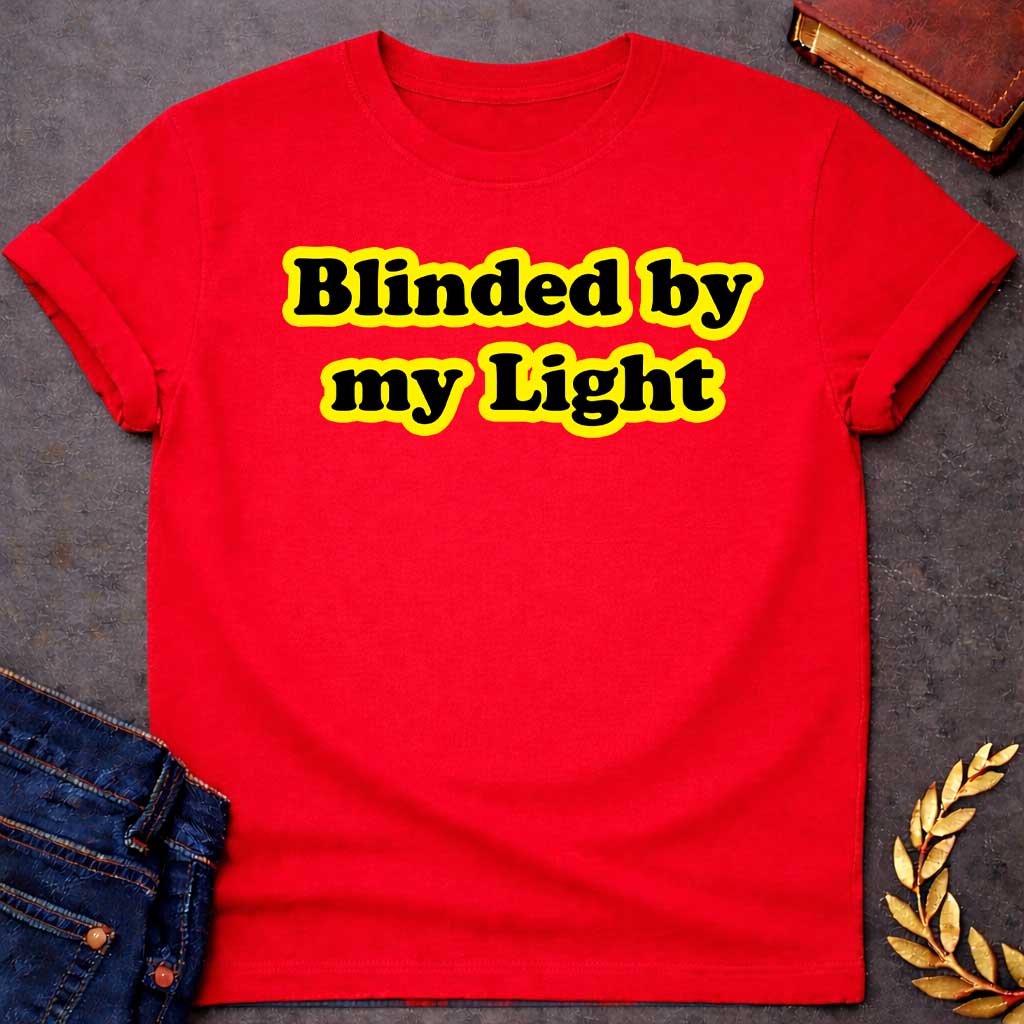 Red T-shirt Streetwear graphic design featuring the phrase "Blinded by my Light" in bold black bubble typography with a vibrant yellow glow. Retro-style aesthetic inspired by Greek mythology and Apollo, the god of light