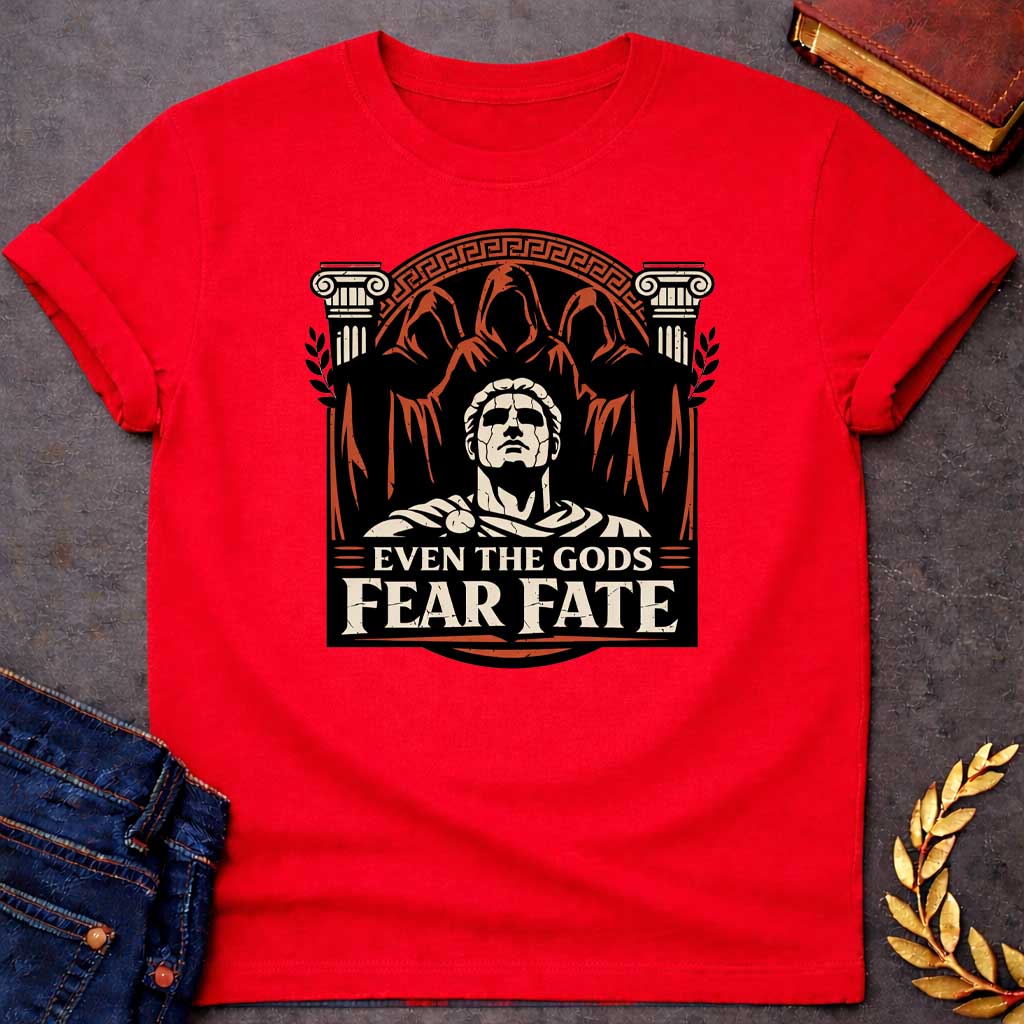 Red shirt featuring a striking graphic design with a classical Greek aesthetic. In the center, a cracked marble bust of a Roman figure gazes upward, flanked by two Ionic columns. Looming behind the statue are three shadowy, hooded figures representing the Fates. The scene is enclosed in a circular Greek key border. The color palette is a bold trio of cream, burnt orange, and black. Below the art, the text reads "EVEN THE GODS" in a clean serif font and "FEAR FATE" in large, distressed block letters